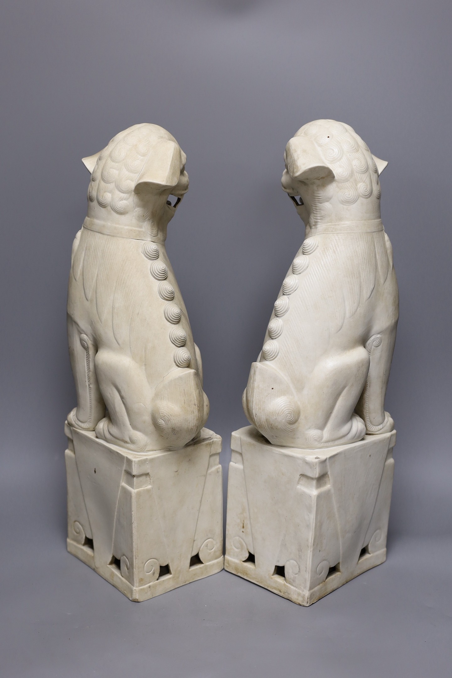 A pair of large Chinese biscuit porcelain lion-dog figures, 45cms high